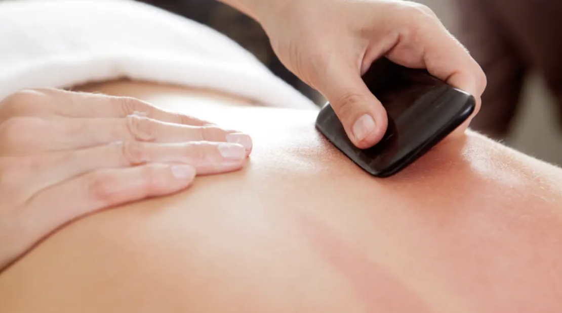 Gua sha on back using obisidian tool